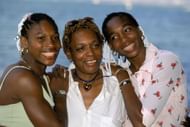 Serena Williams (leftmost) and Venus Williams (rightmost) pose for a photo with their mother Oracene in 1999.